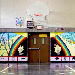 Image of two women on either side of a rainbow